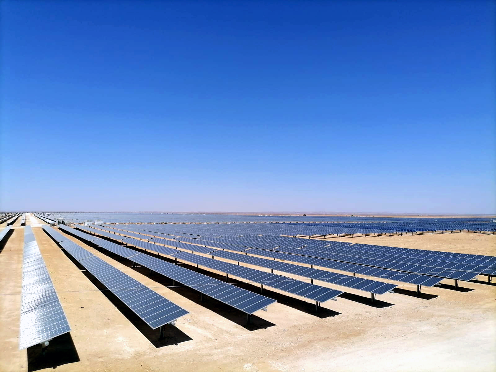 Wide view of the Al-Husainiyah utility-scale solar field in Ma'an, Jordan