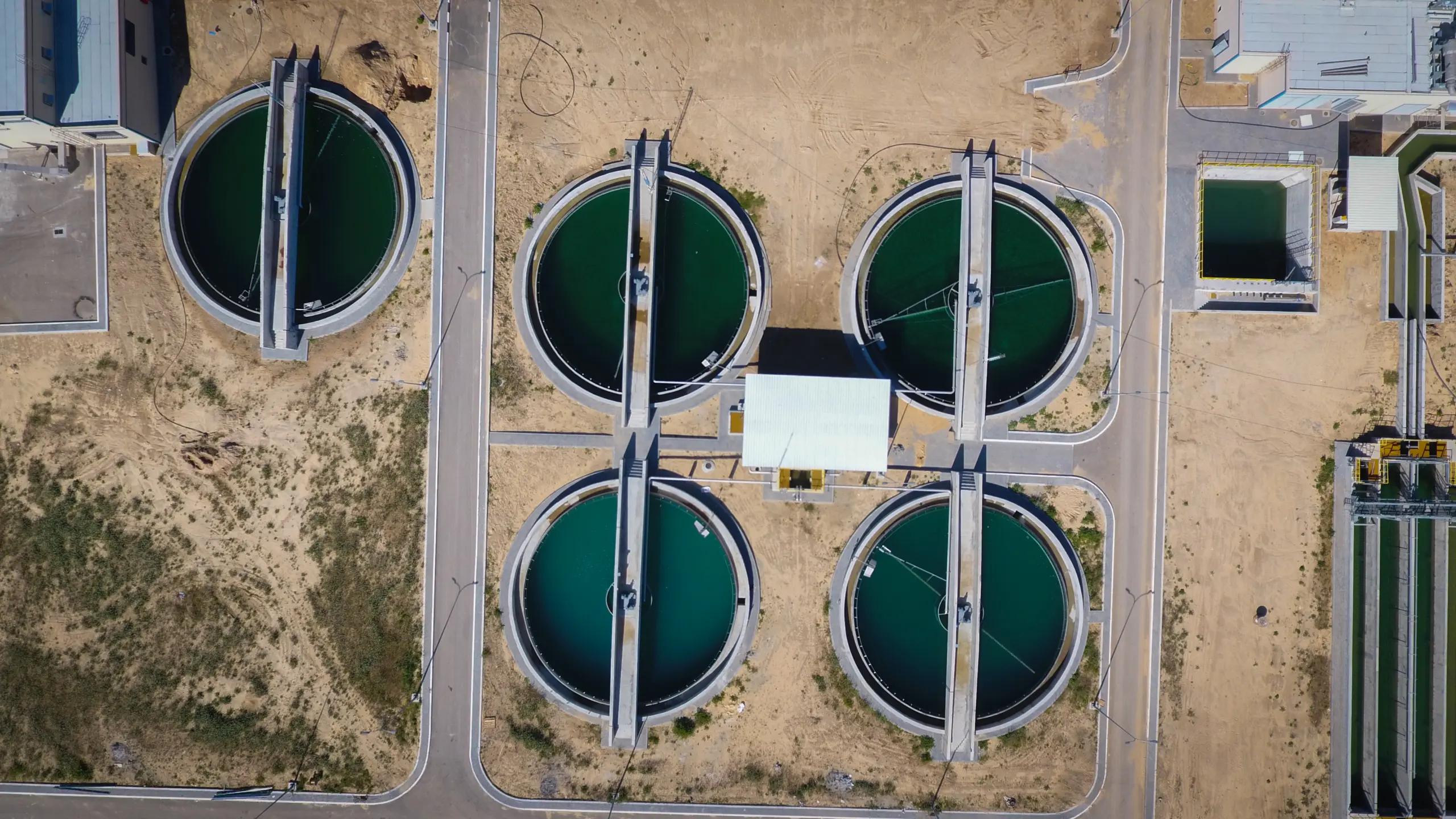 Top-down view of circular water treatment tanks at Gaza Central treatment plant