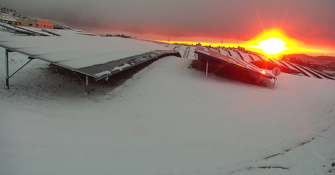 Snow-covered solar arrays illustrating heavy mechanical loading conditions