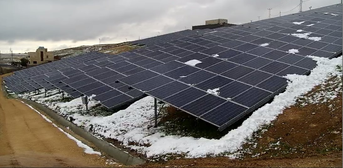 Snow-covered photovoltaic arrays demonstrating winter mechanical loading conditions