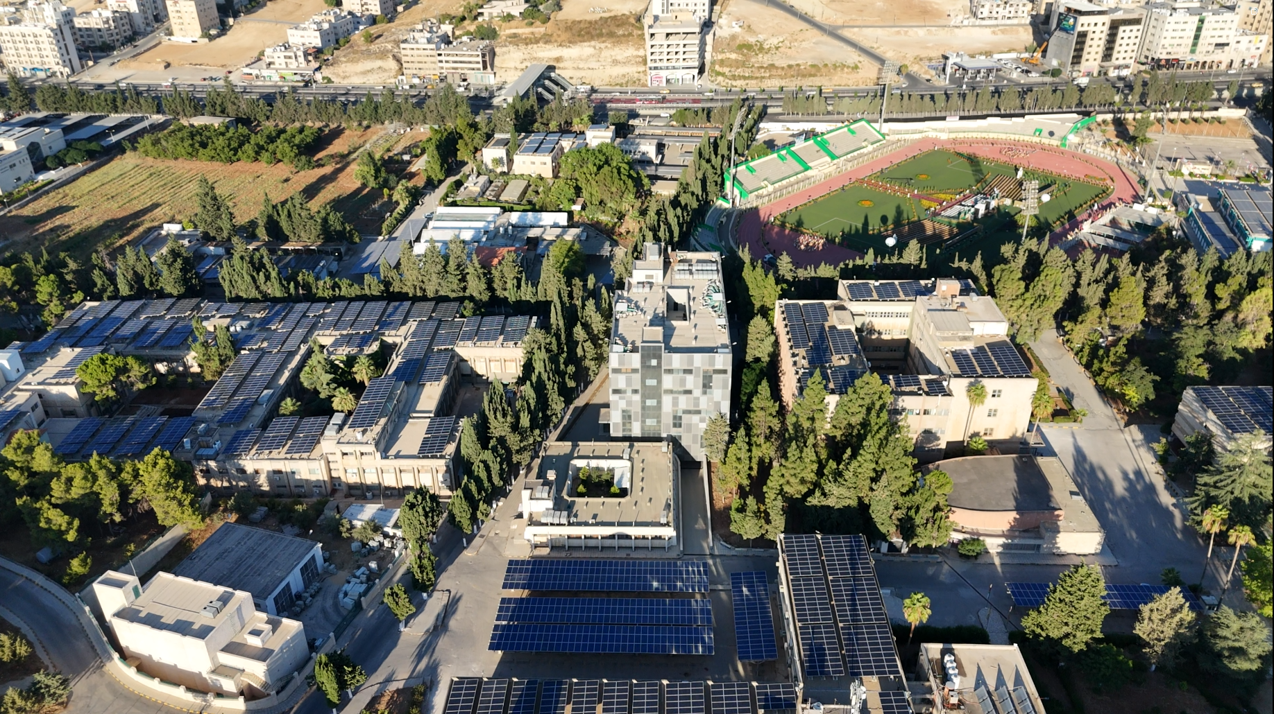 Aerial view of University of Jordan campus with rooftop and carpark solar installations